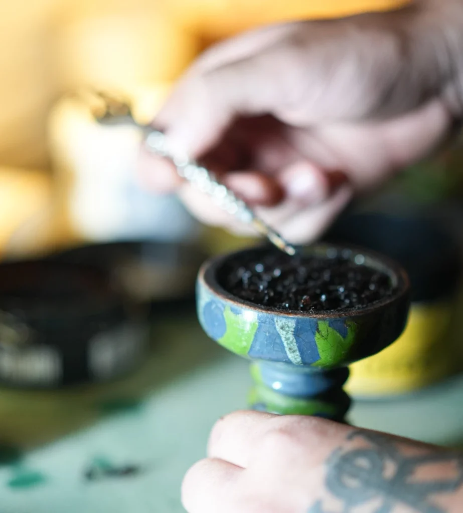 A close-up of the fluff pack preparation method for Mezza North tobacco in a shisha bowl for the best airflow and cooling experience.