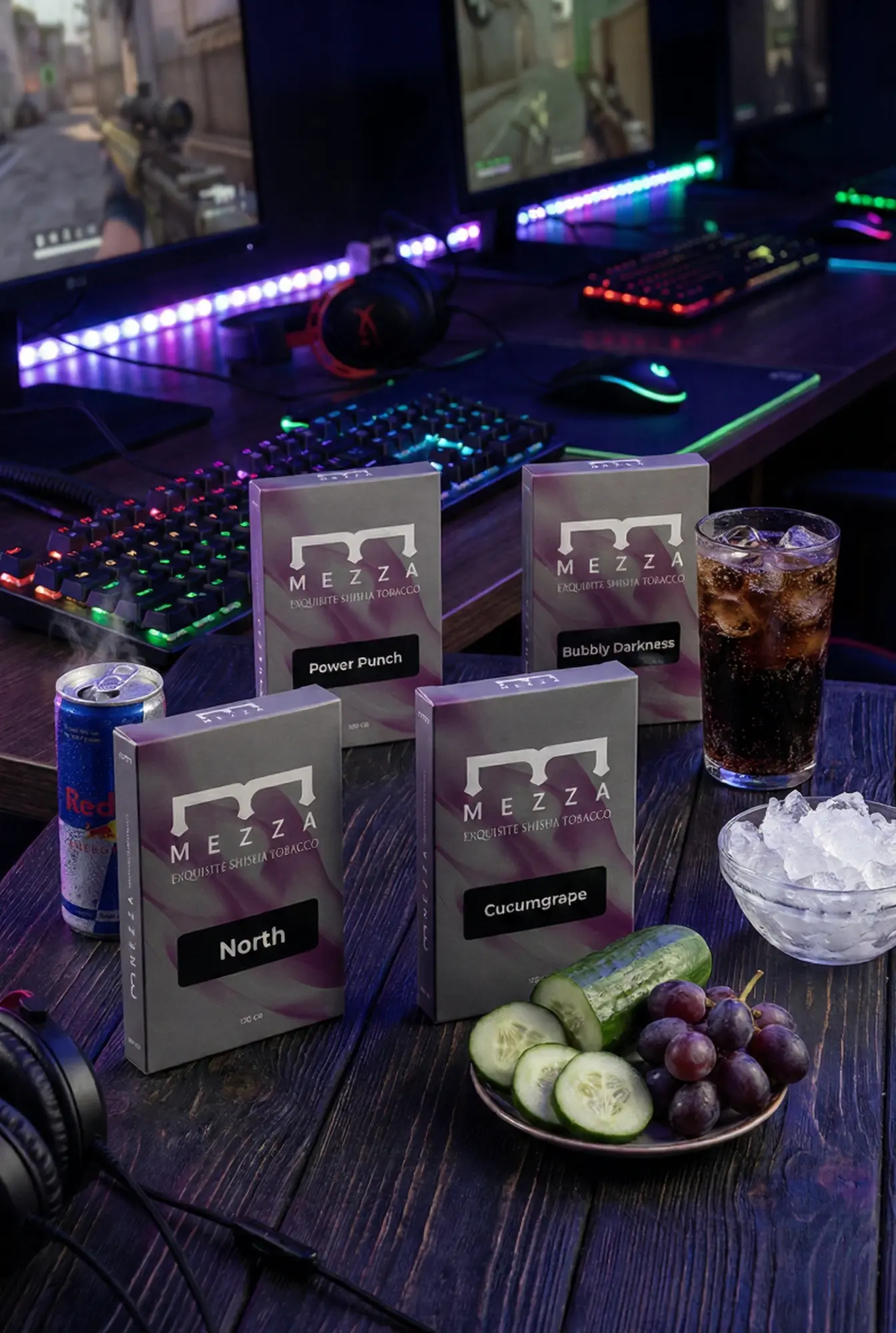 A late-night gaming setup featuring the Midnight Punch hookah flavor mix, displaying Mezza tobacco boxes of Power Punch, Bubbly Darkness, North, and Cucumgrape, alongside an energy drink, iced cola, cucumber slices, and fresh grapes.