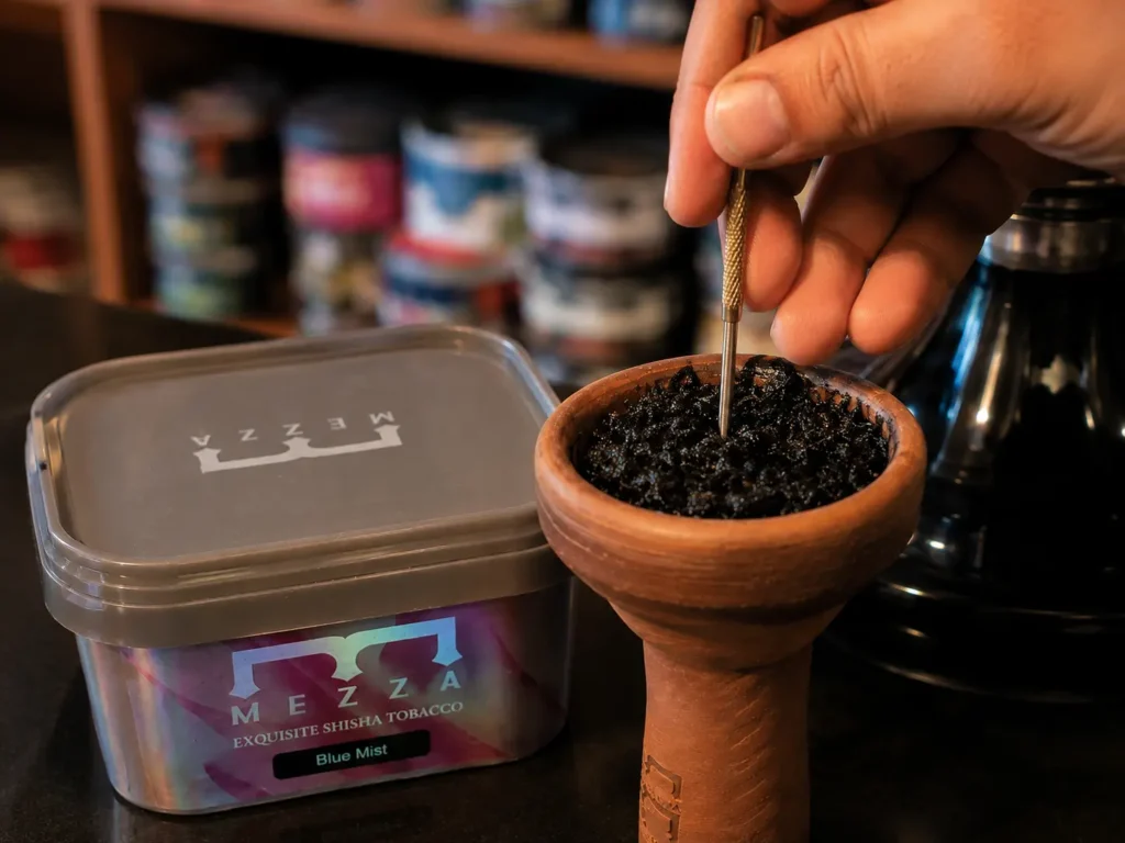 Packing Mezza shisha tobacco into a bowl and gently pressing it with a packing tool | Fluff vs Dense Pack